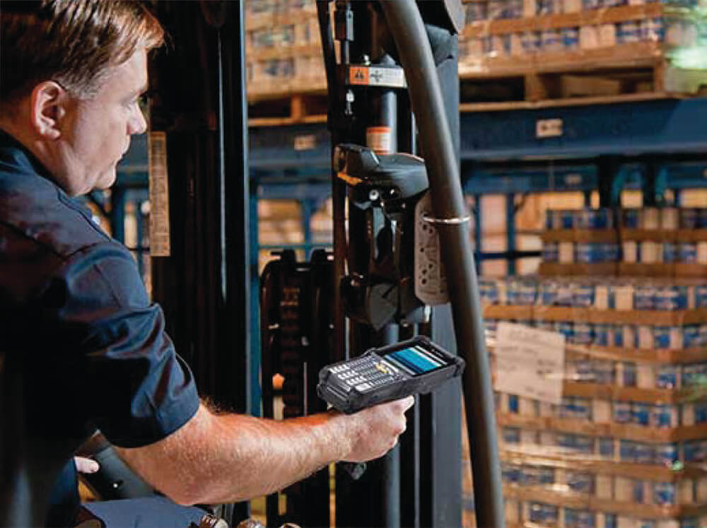 man using scanner in warehouse for inventory