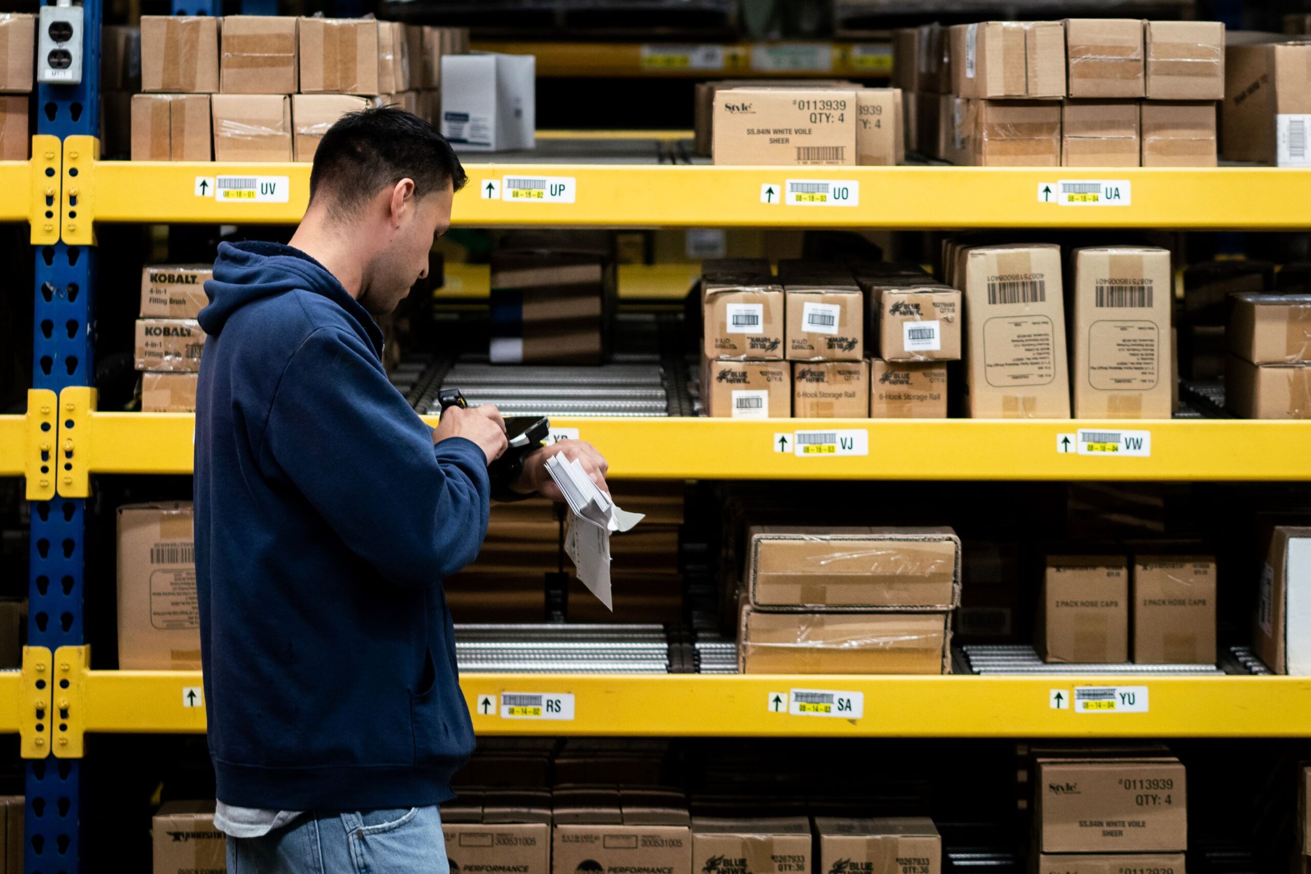 woman using scanner in warehouse for inventory